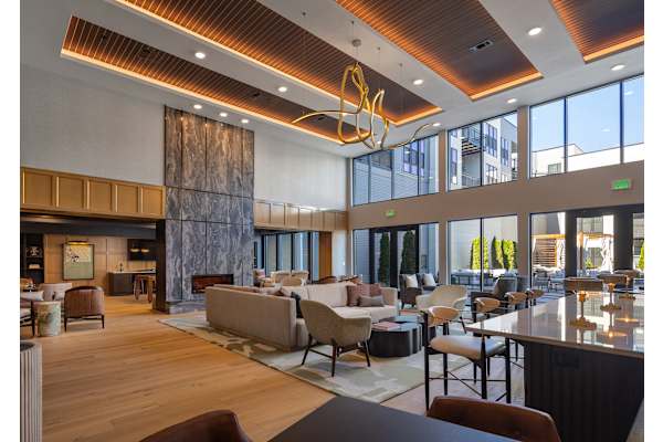 The Plaza at Pinnacle Hills grand lounge with modern living room with a large window and a wooden floor.